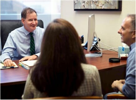 Probate lawyer talking to clients in office